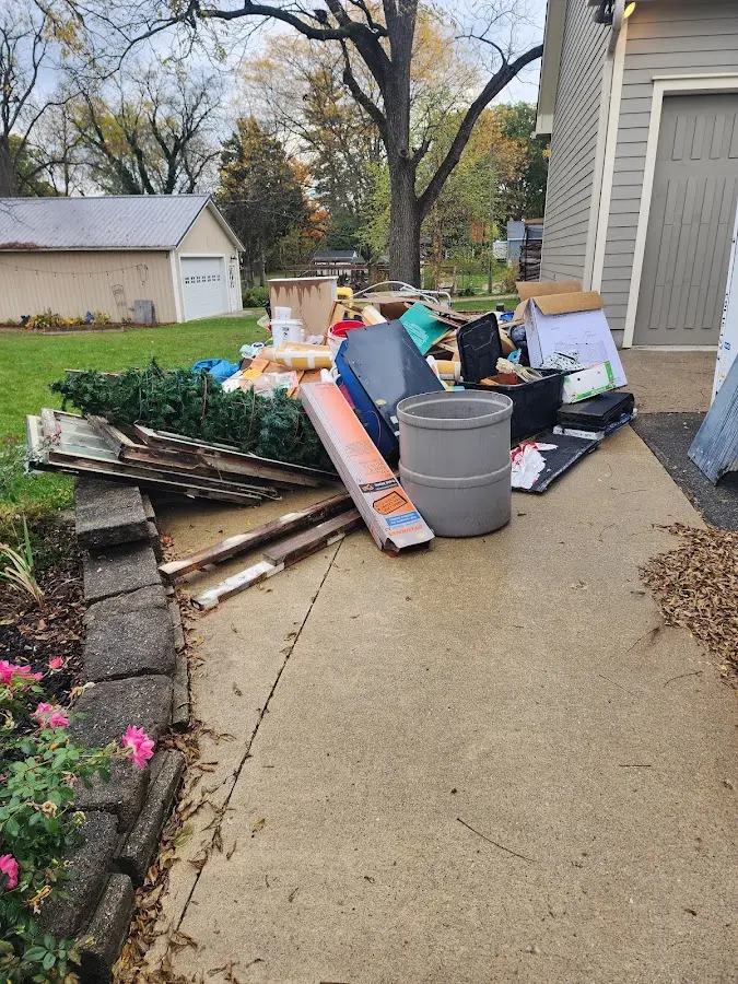 Dumpster being loaded with debris for Estate Cleanout Dumpster Rental in Carrollwood